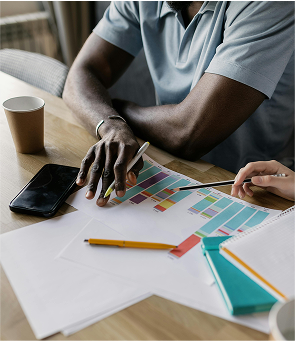 Person working on a laptop and notebook